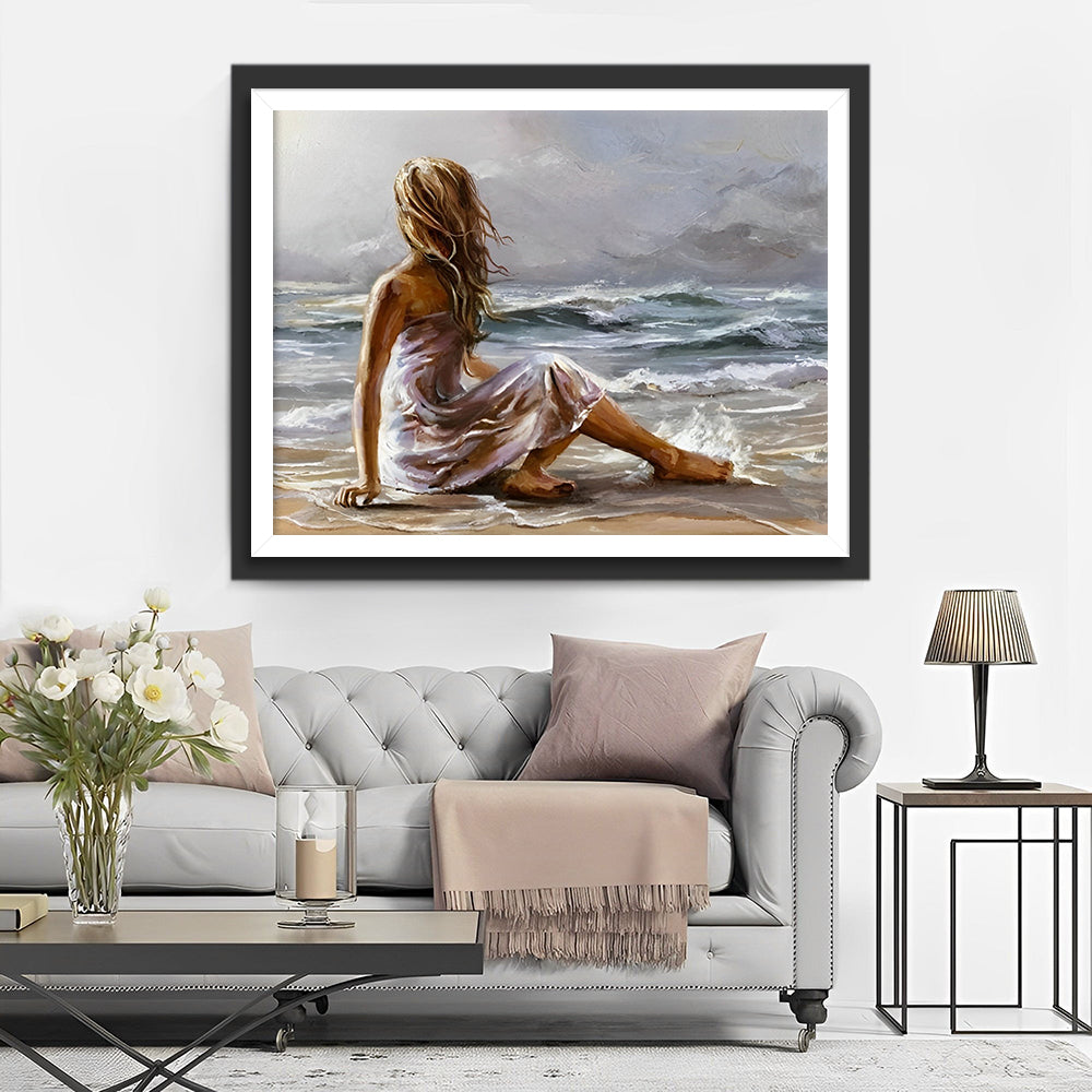 Eine am Strand sitzende Frau Diamond Painting