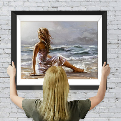 Eine am Strand sitzende Frau Diamond Painting