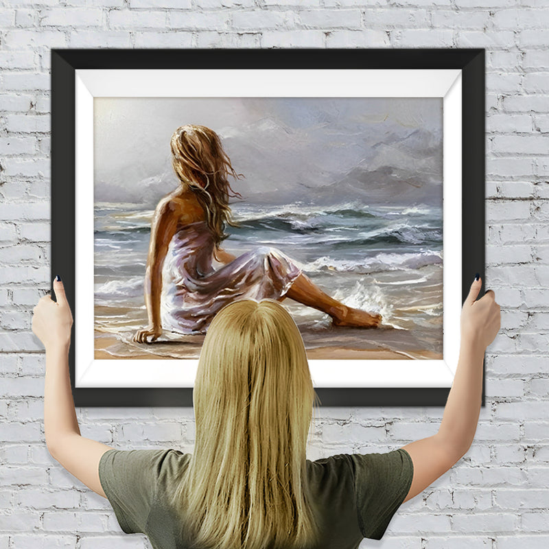 Eine am Strand sitzende Frau Diamond Painting