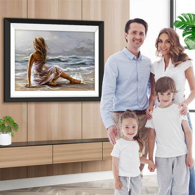 Eine am Strand sitzende Frau Diamond Painting