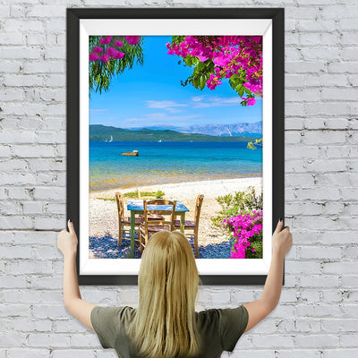 Holztisch und Stühle am Meer Diamond Painting