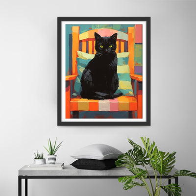 Schwarze Katze auf einem bunten Stuhl Diamond Painting