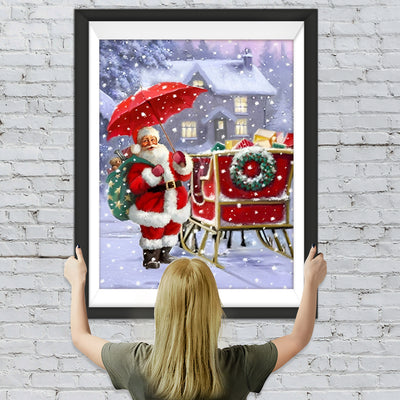 Weihnachtsmann mit einem Regenschirm im Schnee Diamond Painting