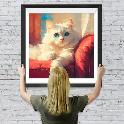 Weiße Katze auf rotem Sofa Diamond Painting